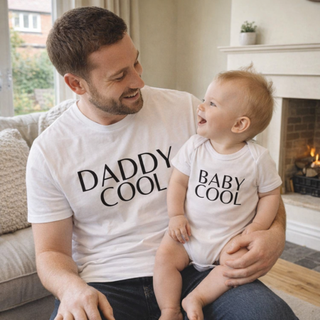 dad and baby wearing matching daddy cool baby cool tops