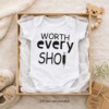 A white baby vest that says Worth every shot for IVF pregancyies and miracle babies