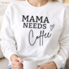 mum wearing a sweatshirt that says mama needs coffee