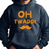 A person wearing a dark hoodie with bright orange text reading “OH TWADDI” and an orange mustache graphic printed beneath it. Punjabi Slogan