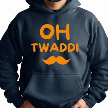 A person wearing a dark hoodie with bright orange text reading “OH TWADDI” and an orange mustache graphic printed beneath it. Punjabi Slogan